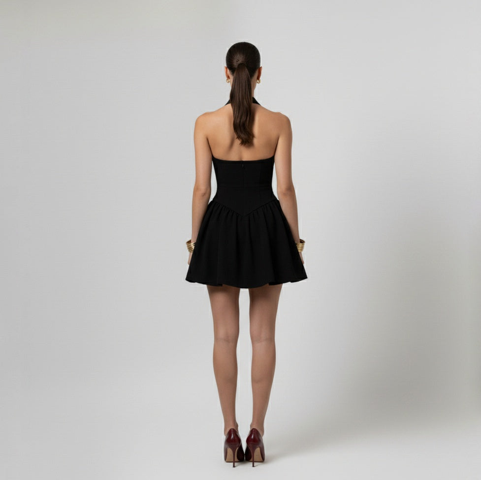 Woman wearing a Black halter neck dress on a white background