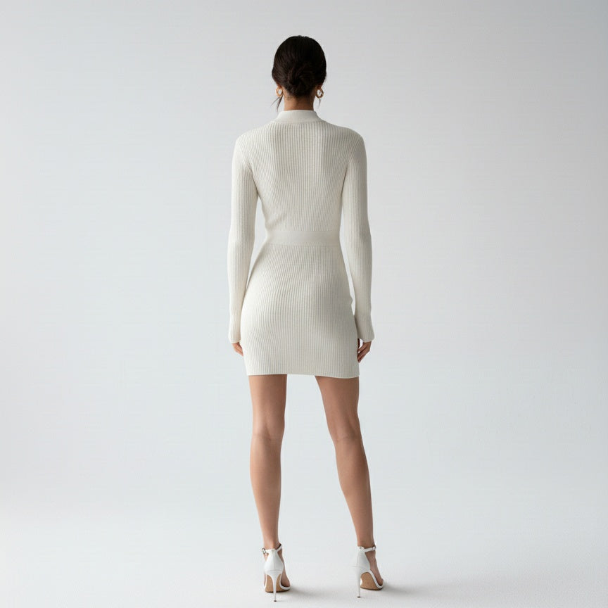 Back view of a model wearing the CELESTE KNITTED MINI DRESS in white, showcasing its elegant high-neck design.