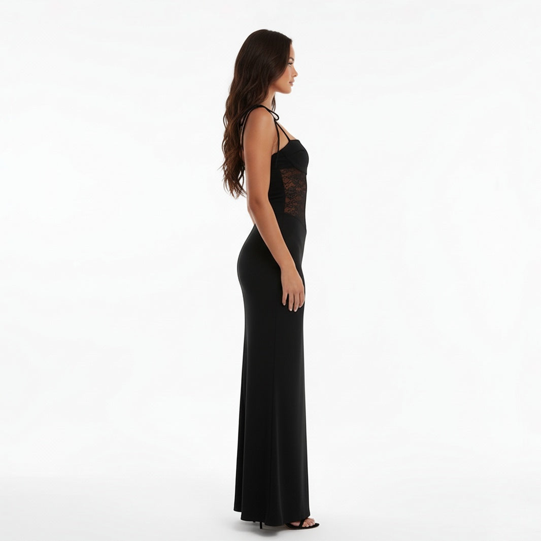 Woman wearing a Black evening gown with lace detailing on a white background