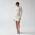 CELESTE KNITTED MINI DRESS in elegant high-neck design, made from cozy knitted fabric, perfect for winter gatherings.