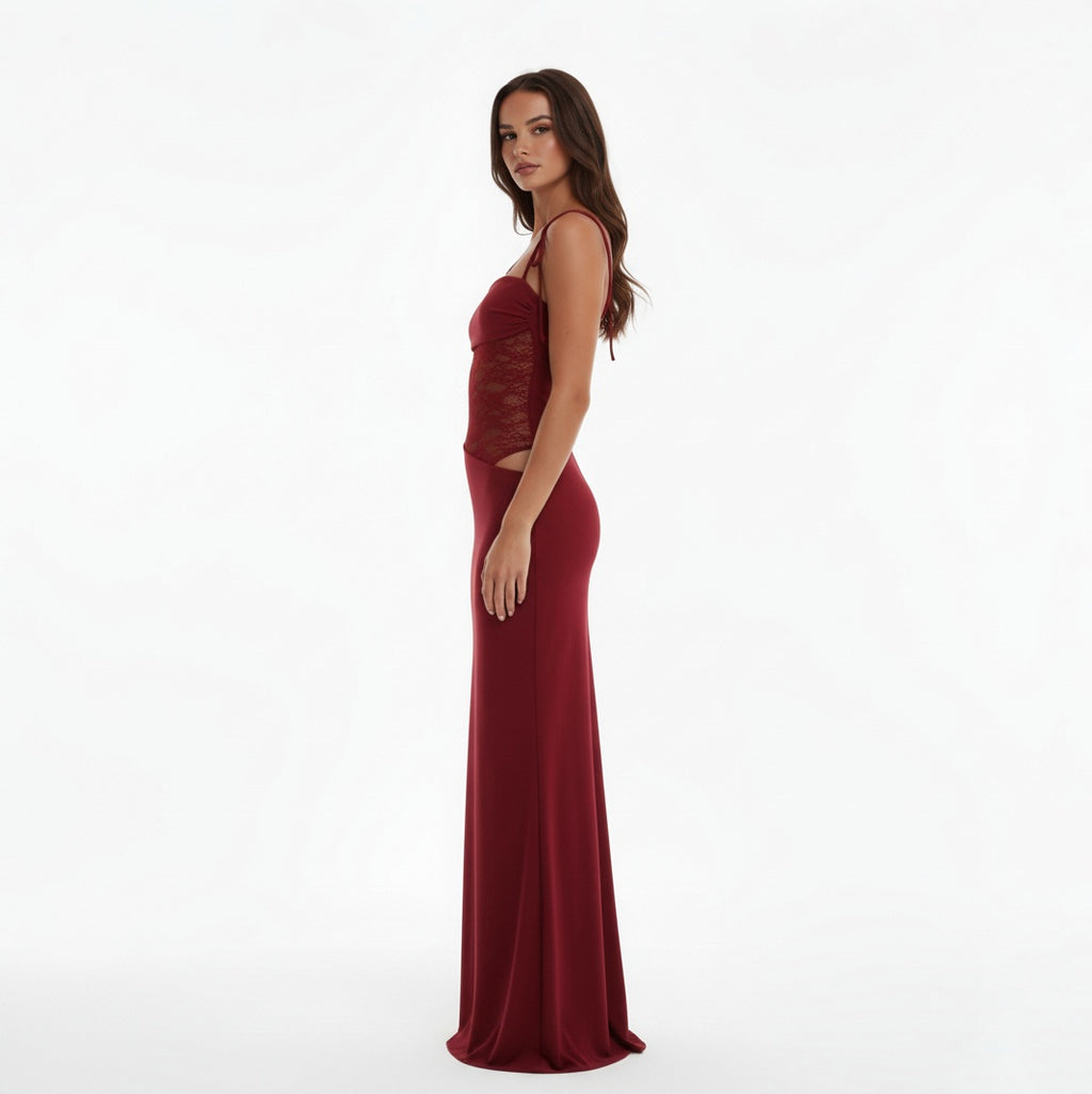 Woman wearing a Claret evening gown with lace detailing on a white background