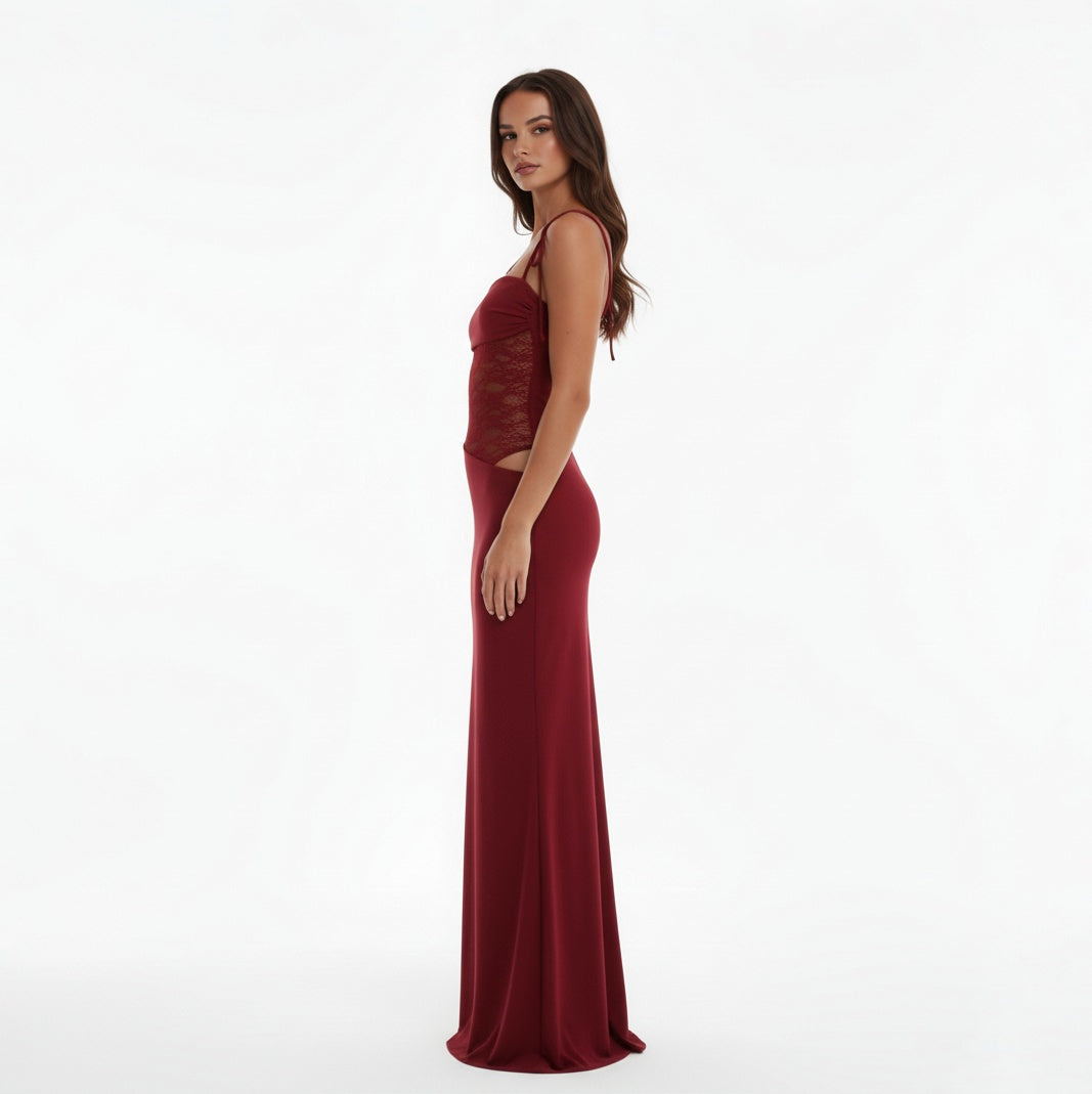 Woman wearing a Claret evening gown with lace detailing on a white background