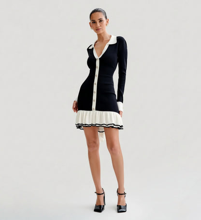 Woman wearing a Black and white dress on a plain background