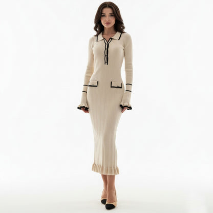 Woman wearing a beige dress with black accents on a white background
