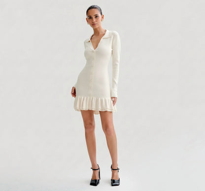 Woman wearing a Ivory dress with long sleeves on a plain background