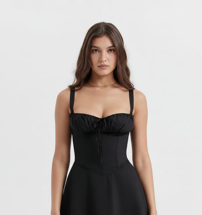 Woman wearing a Black evening gown with lace detailing on a white background