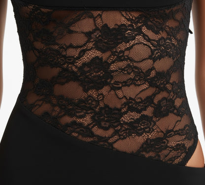 Black lace garment on a plain background